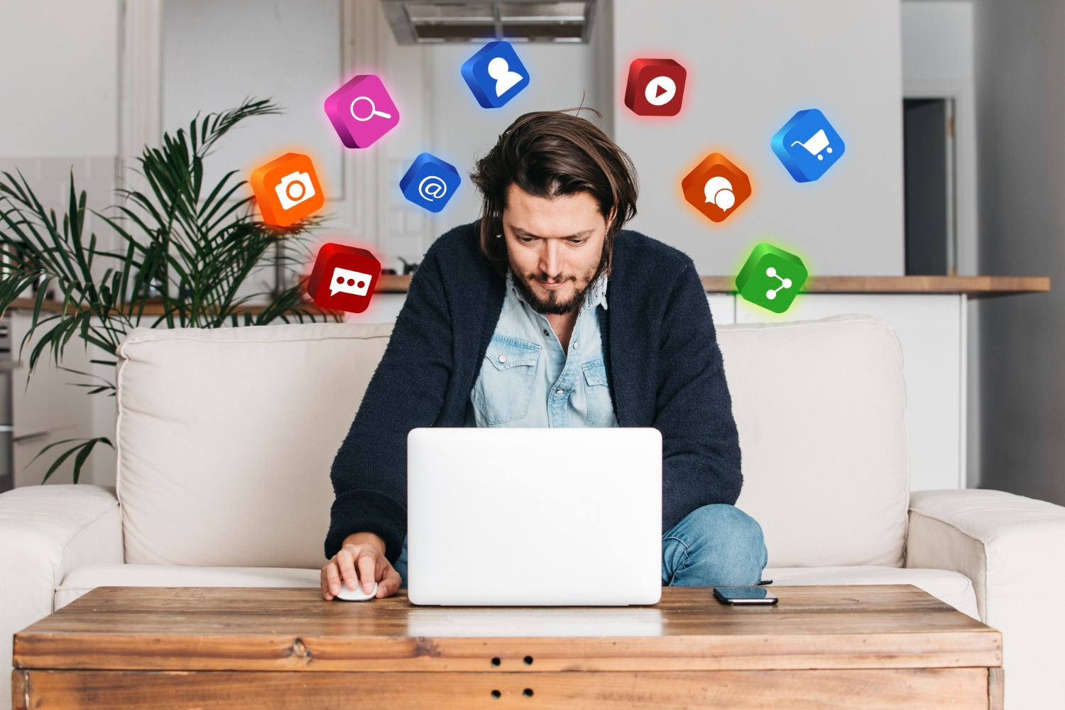 Man working on a laptop with floating social media icons representing marketing and digital engagement.